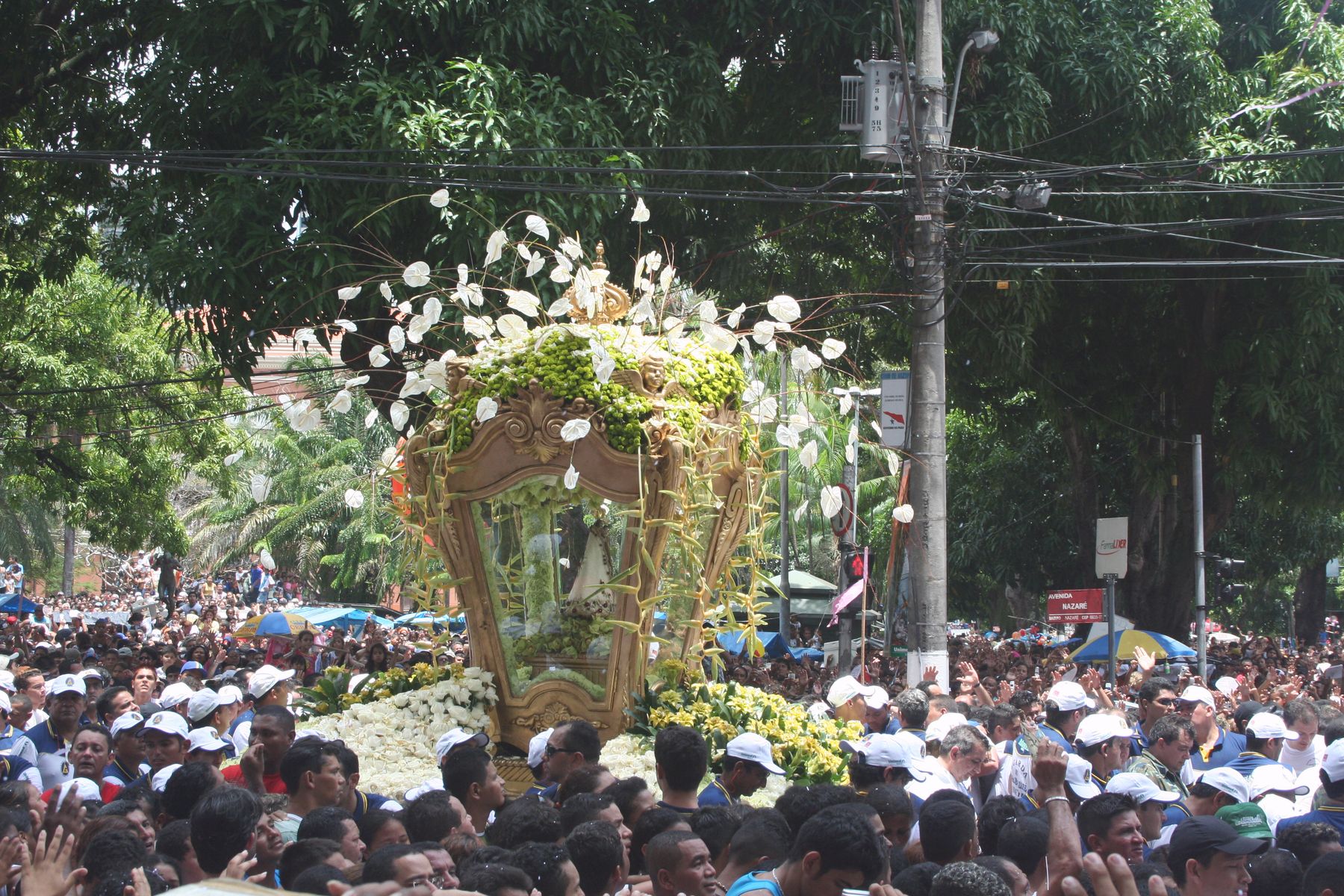 The flower-decked berlinda carrying Our Lady of Nazareth through crowds at the Círio procession in Belém