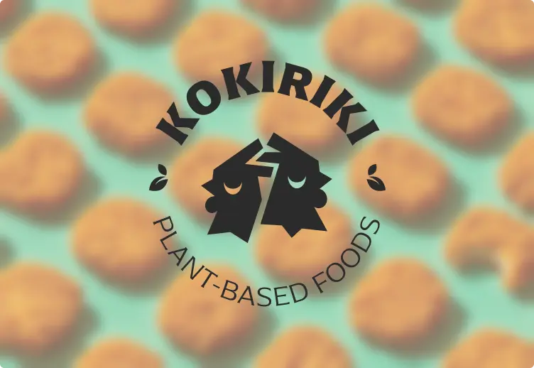 Kokiriki logo on blurred nuggets photograph — brand mark application with warm desaturated food photography