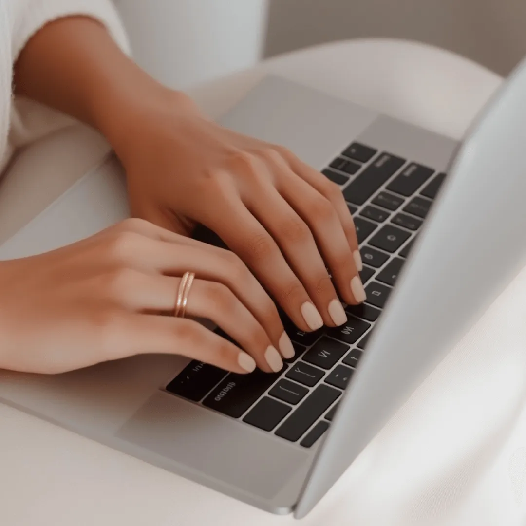 Typing on Silver Laptop