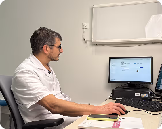 A Pixacare team member works on a computer in an office.