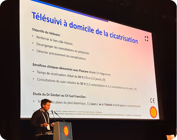 Presentation on a screen with the title "Home Telemonitoring of Wound Healing" during a conference given by Mathis Ringdal, co-founder of Pixacare