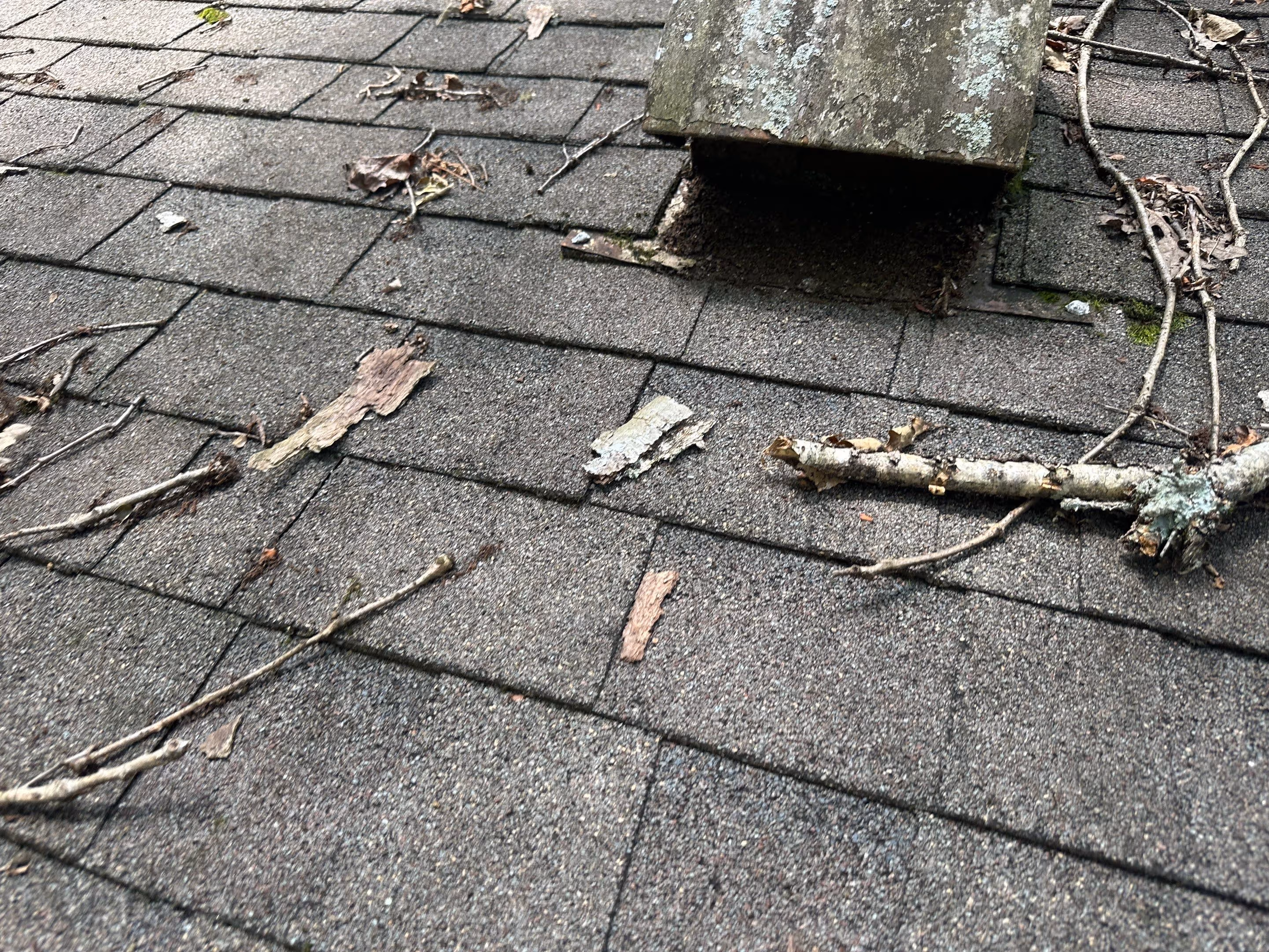 Roof with visible damage marked using chalk circles highlighting wear, cracks, and potential leak areas