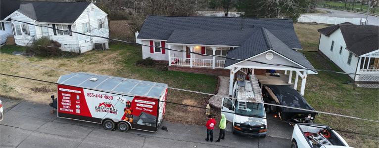 Hail impact damage on shingles marked with irregular chalk circles during roof inspection