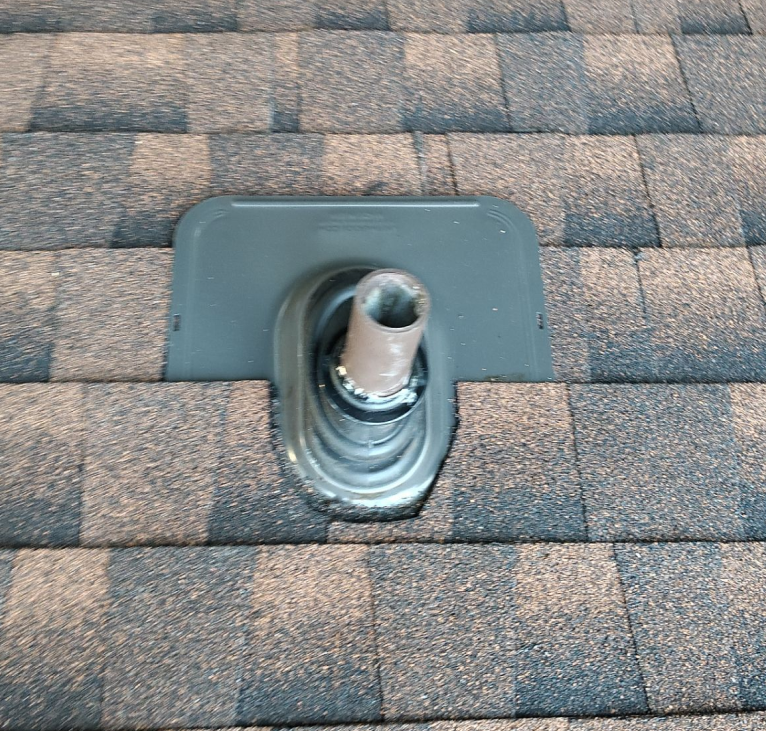 Professional roof inspector examining asphalt shingles up close to identify damage and assess roof condition