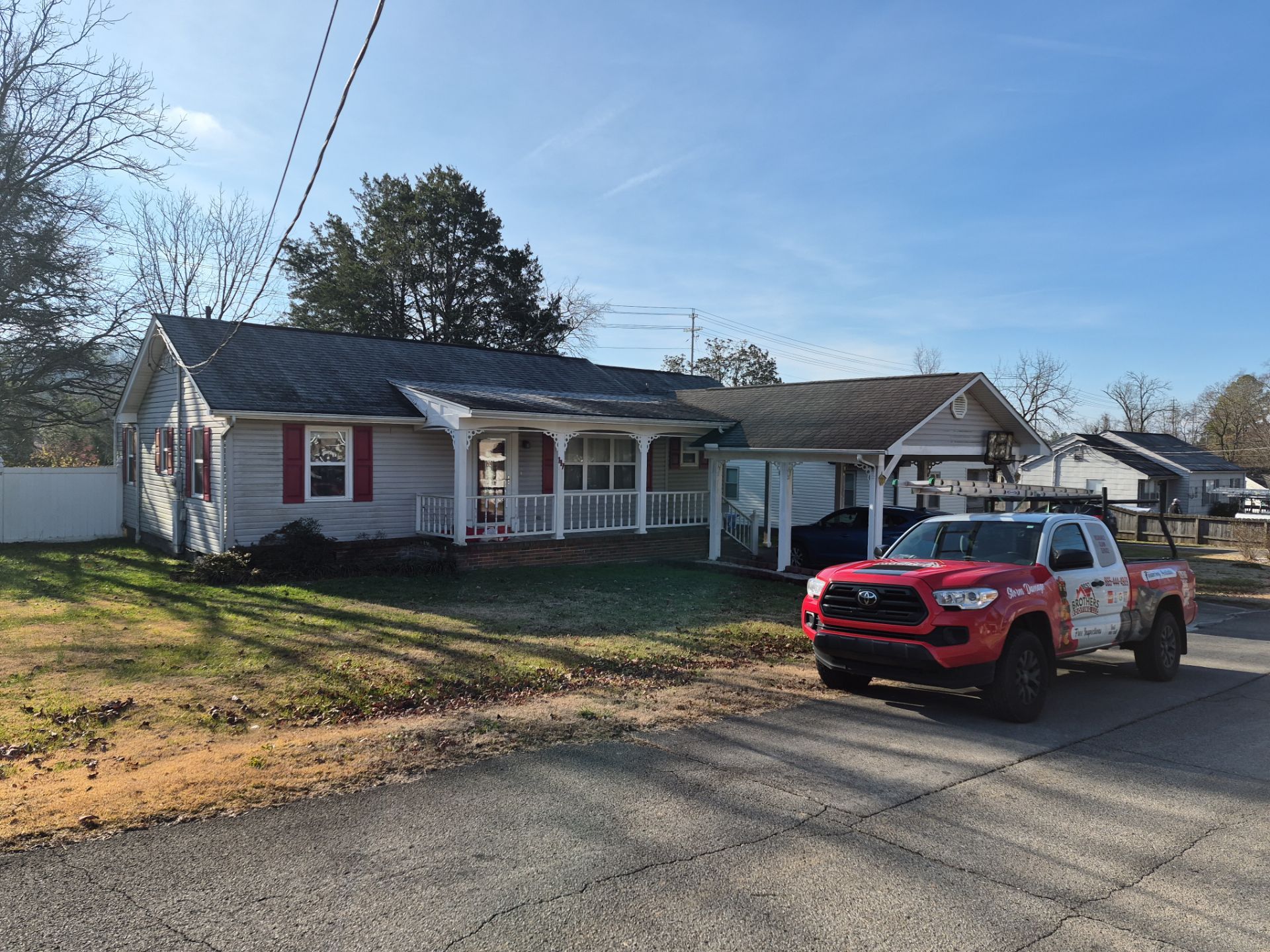 Best Brothers Roofing truck at a residential home