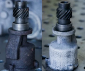 Side-by-side comparison of a mechanical part before and after cleaning, showing a rusty dark version on the left and a cleaned, light silver version on the right.