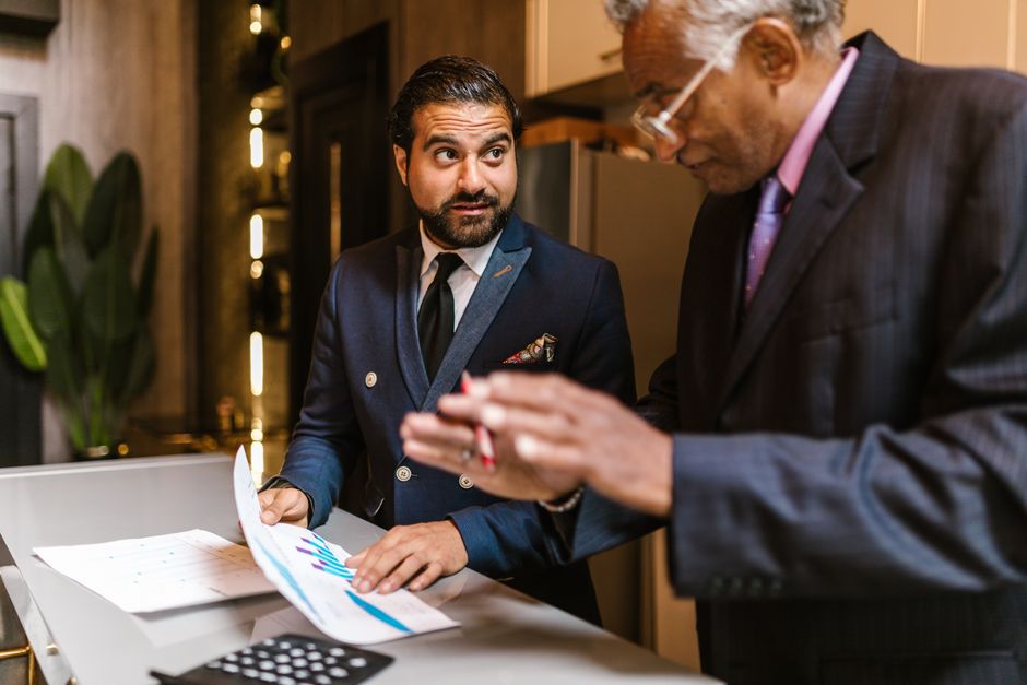 A Houston business owner reviewing financial planning documents with an advisor
