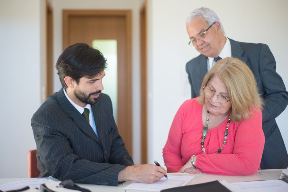 A professional estate planning consultation with legal documents and a pen