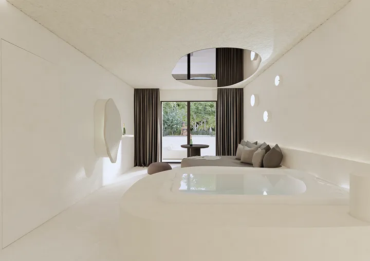 Salon moderne minimaliste aux murs blancs, avec un grand canapé gris, des coussins, une table basse et un mur avec des fenêtres rondes.