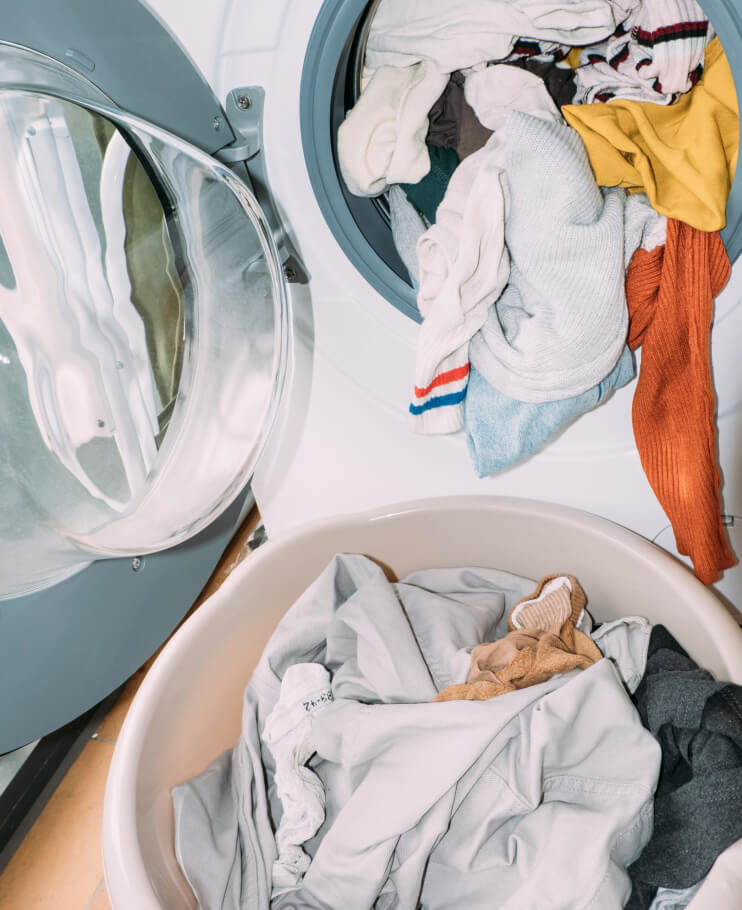 Photo of a washing machine overflowing with laundry