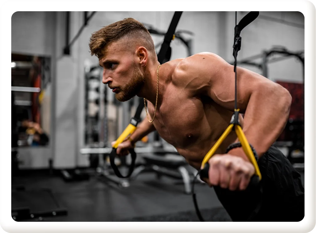 Man performing suspension training exercise to build muscle definition and improve vascularity