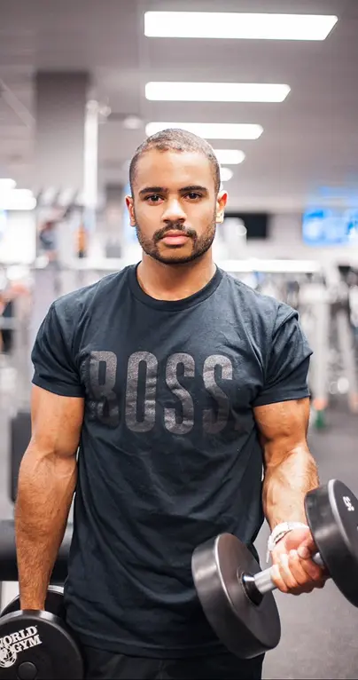 Corey lifting weights in the gym