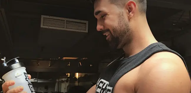 Josh looking at his supplements shaker bottle