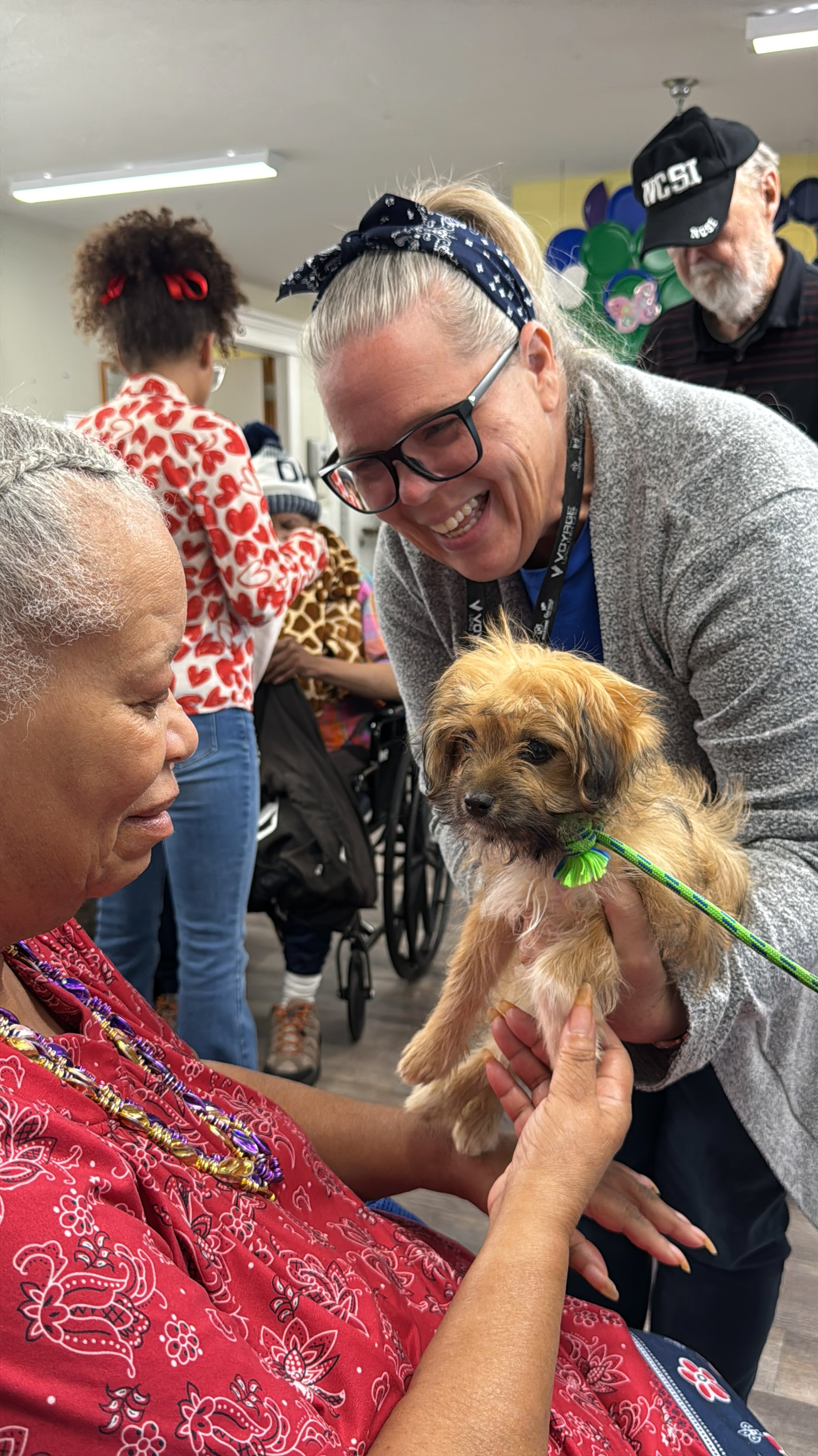 Two women smiling and fist bumping