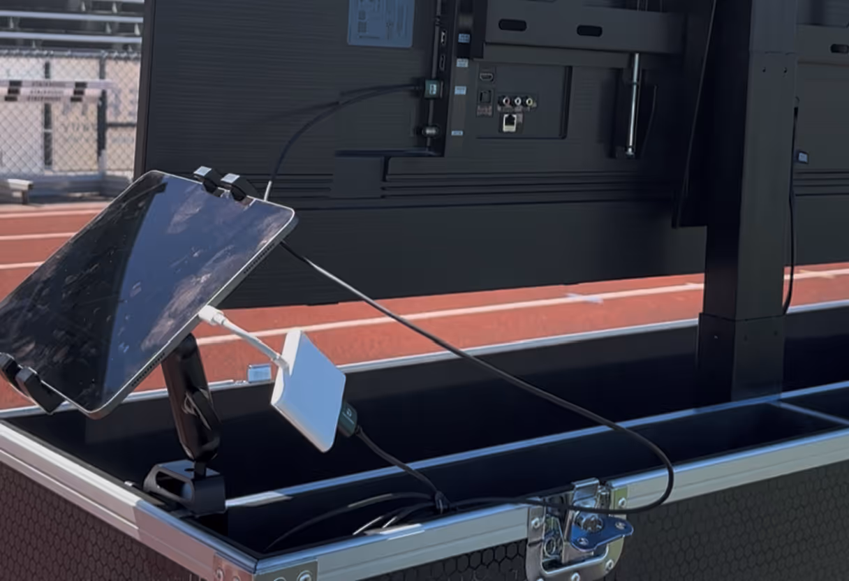 iPad connected to a sideline TV for instant replay viewing of Hudl Sideline app during high school football games.