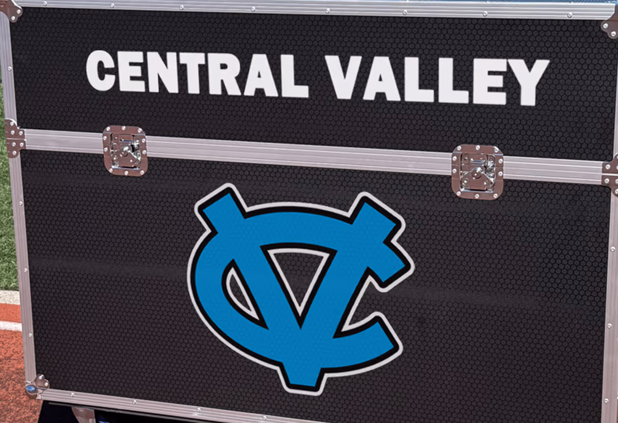Large graphics of school logo and school name on the sideline replay TV box.