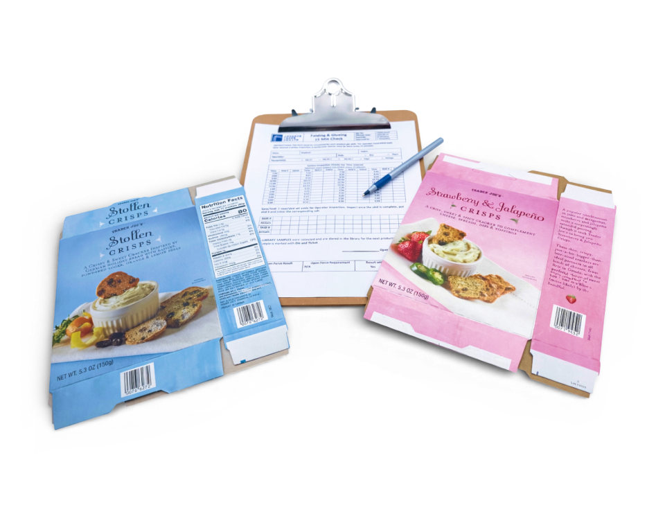 An image of a clip board and two printed food boxes.