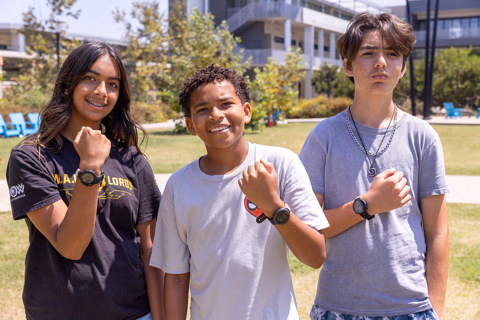 Boy working on a cardboard electronics project labeled 'Let it go' on a classroom table.