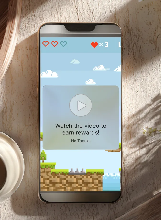 Smartphone displaying a pixelated game with a prompt to watch a video for rewards and a play button.