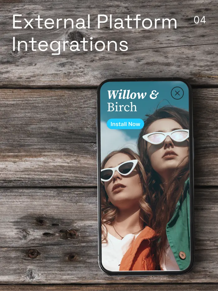 Smartphone on wooden surface showing two women with white cat-eye sunglasses and install button.
