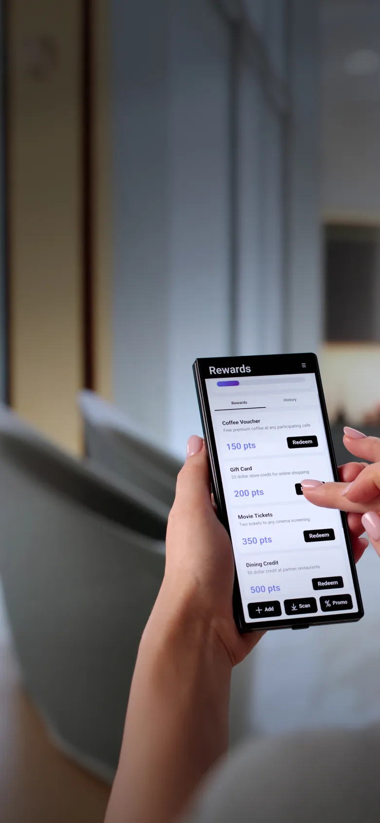 Hand holding phone showing a rewards app with points for coffee, gift card, movie, and dining credits.