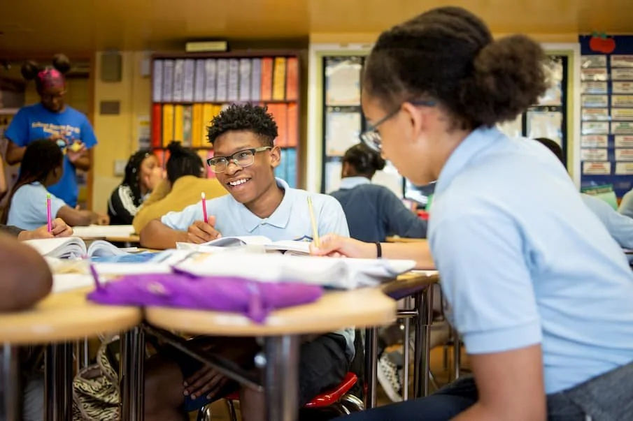 Teacher helping students in classroom
