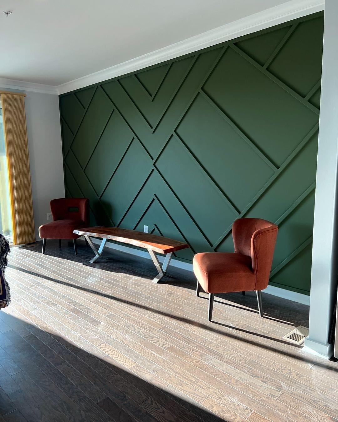 Dark green geometric accent wall paneling with white crown molding in a modern living room in NJ