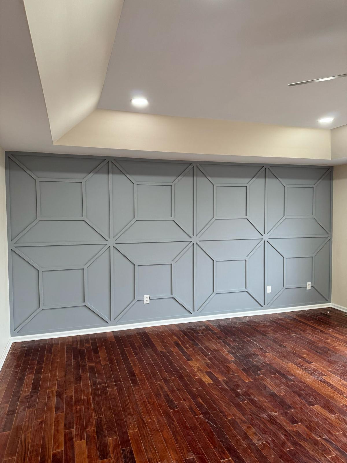 Gray geometric wall paneling and a white tray ceiling in an unfurnished room in New Jersey