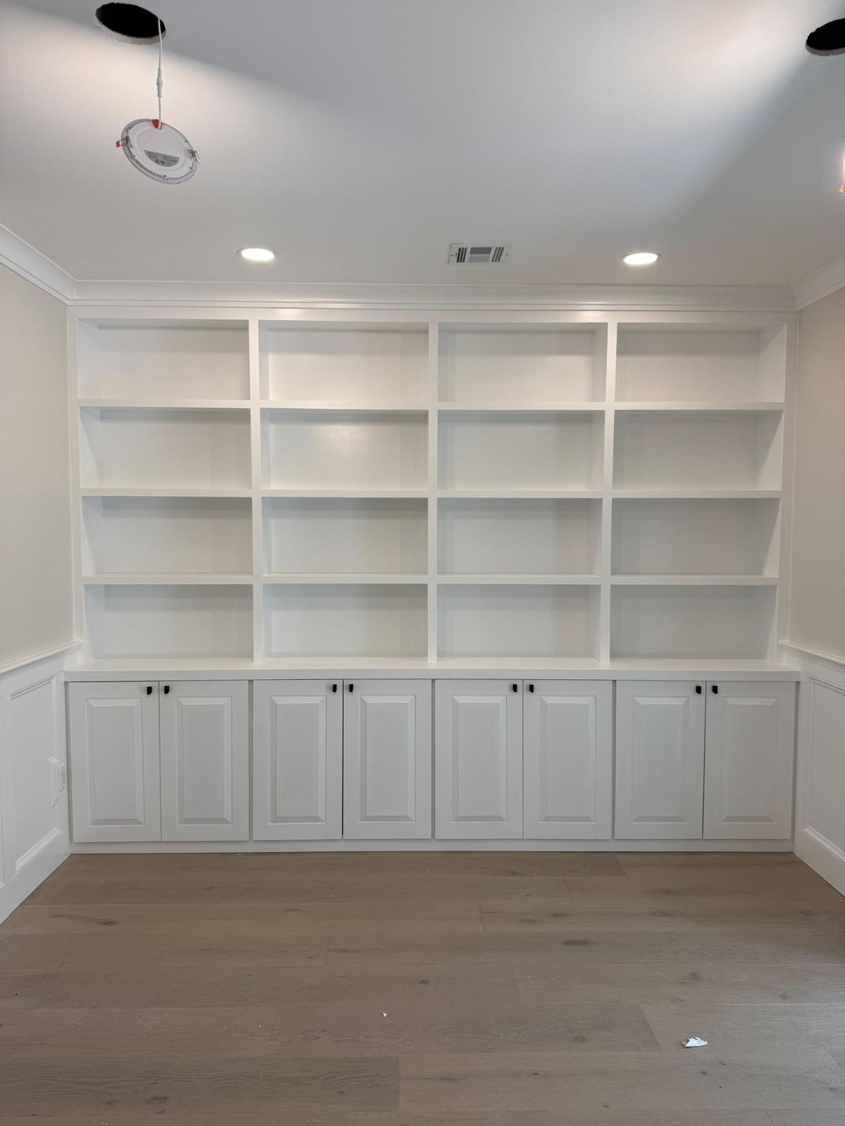 White built-in shelving and lower cabinetry in a New Jersey home office or living room
