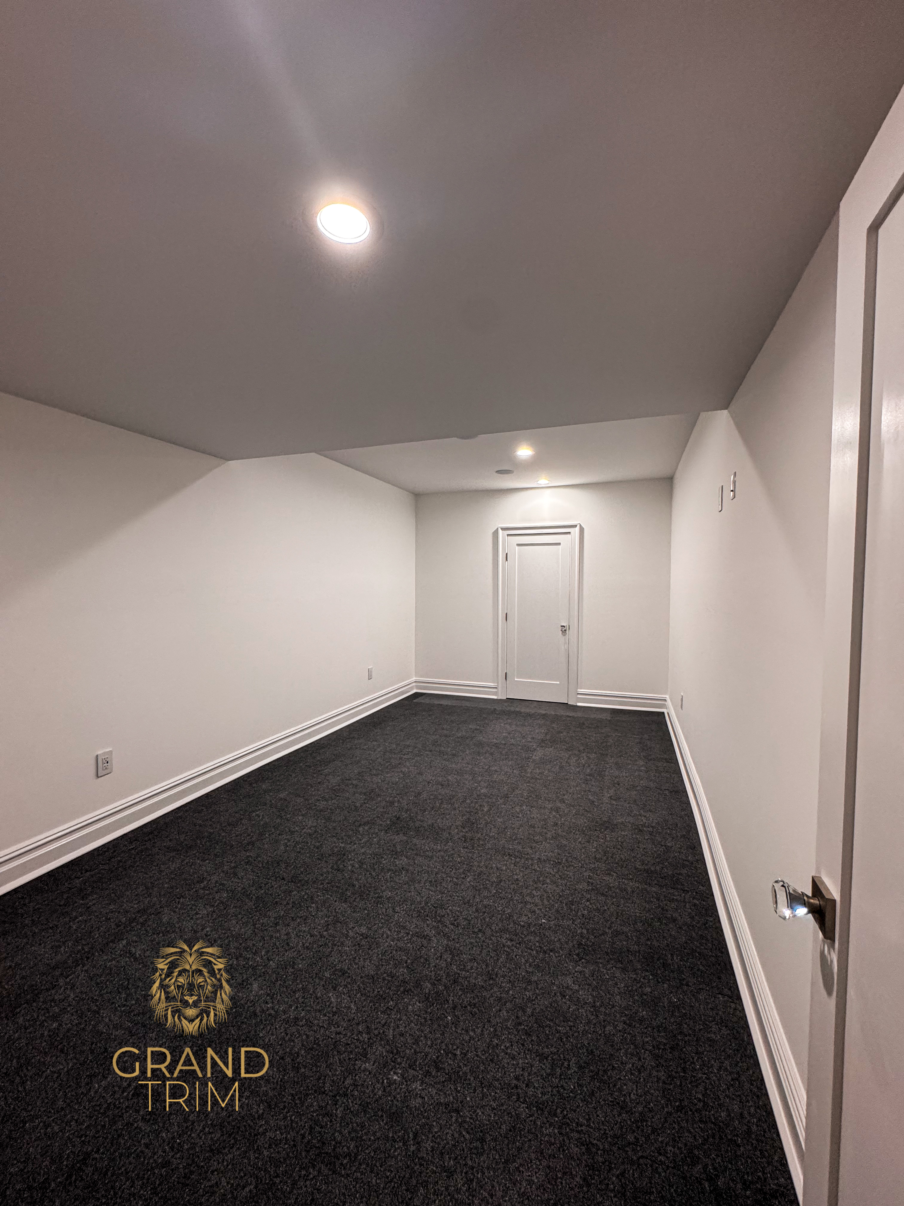 White decorative baseboard trim installed along walls in an empty carpeted room in New Jersey