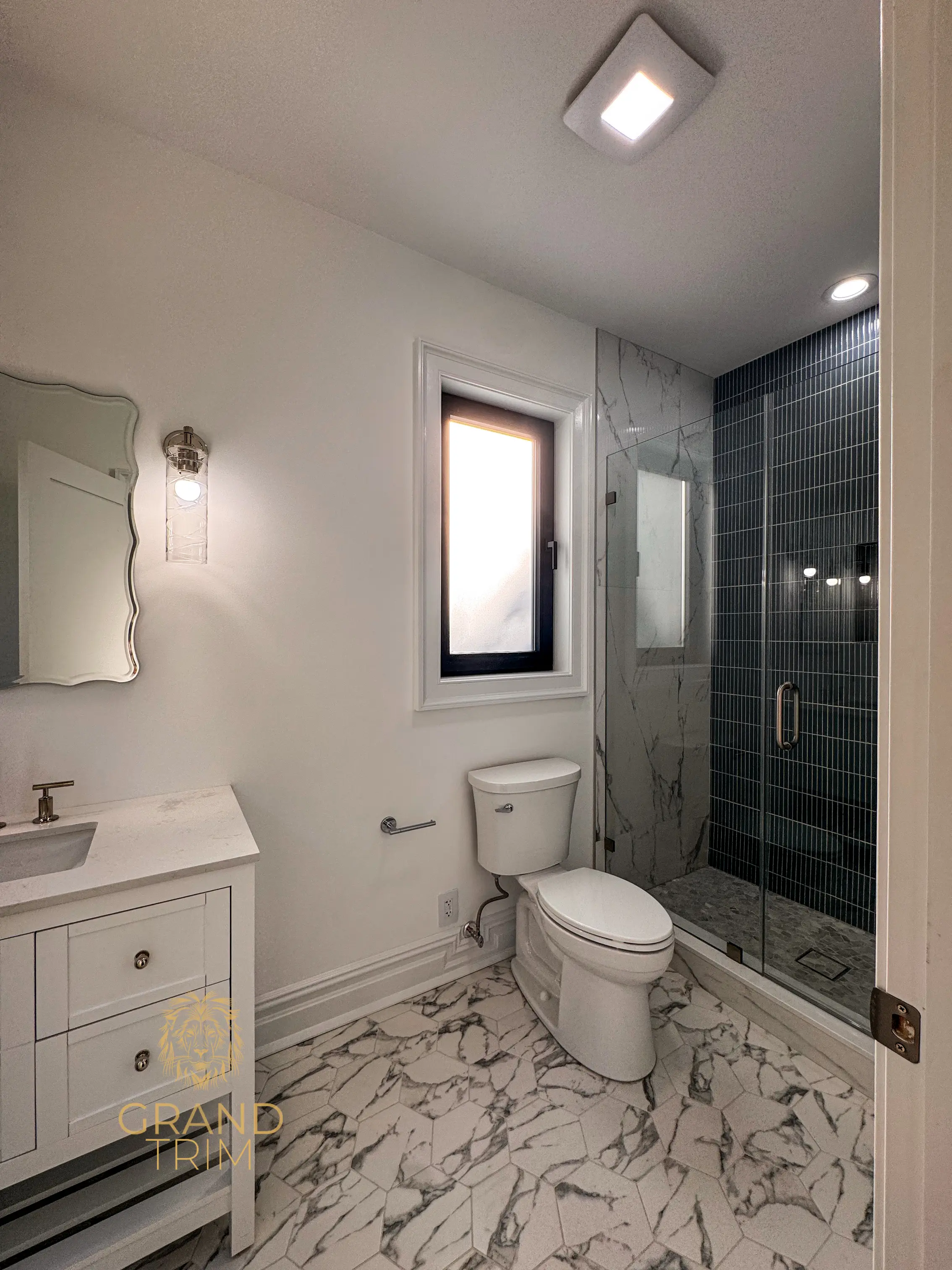 White window trim installation in a modern bathroom with marble-look floor in New Jersey