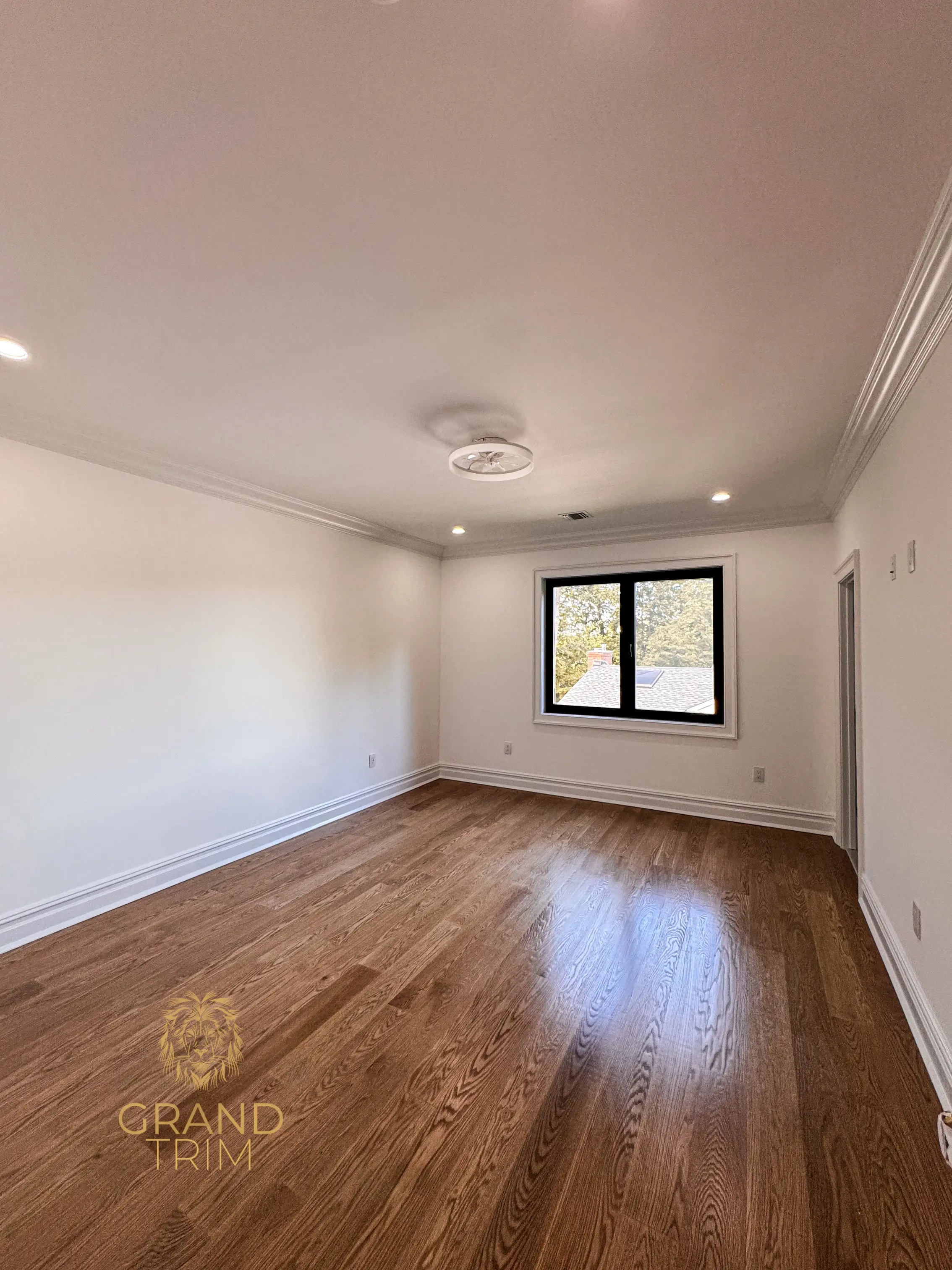 White crown molding and baseboard trim installation in an empty New Jersey room