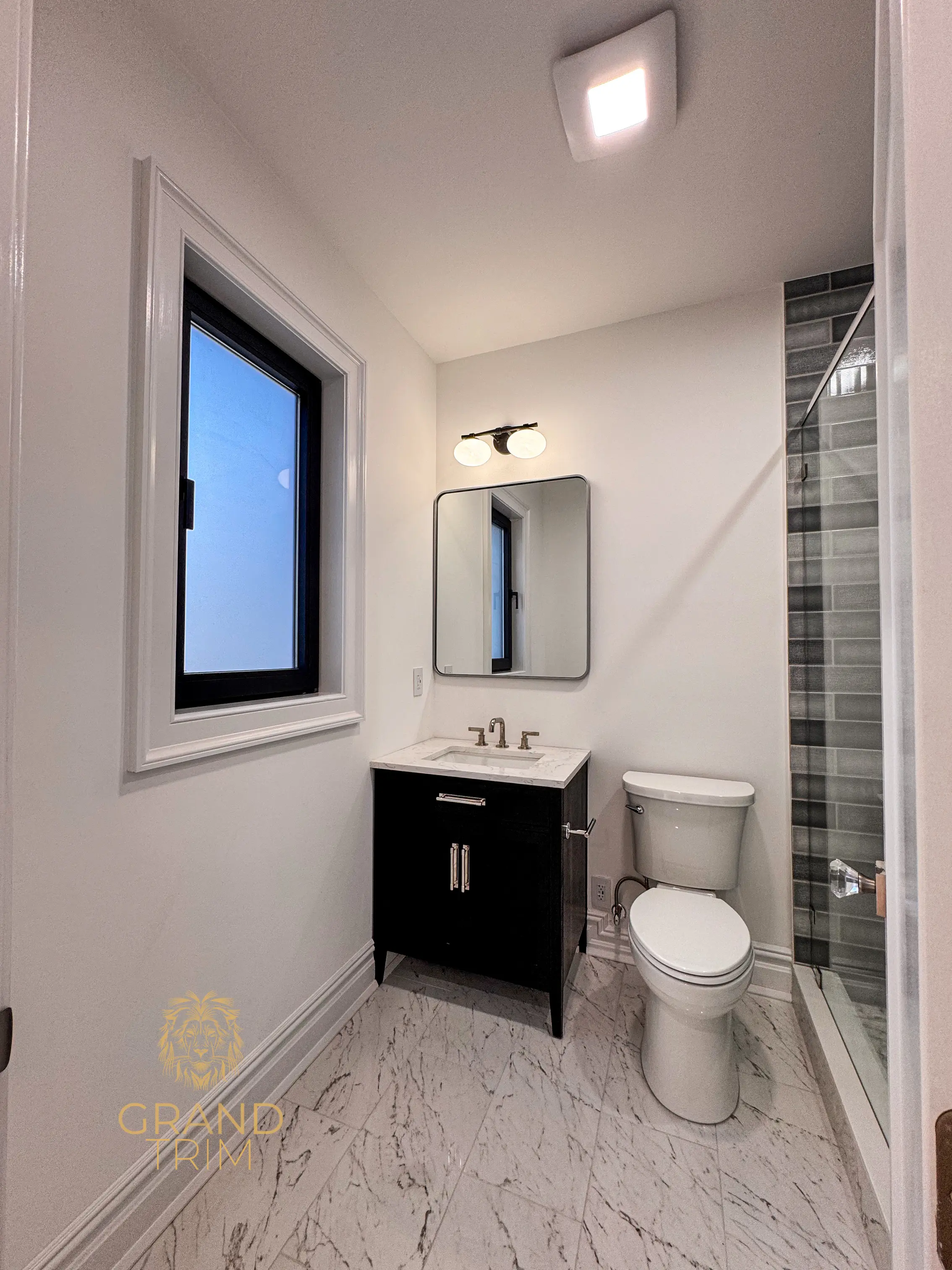 White window and door trim installation in a modern New Jersey bathroom