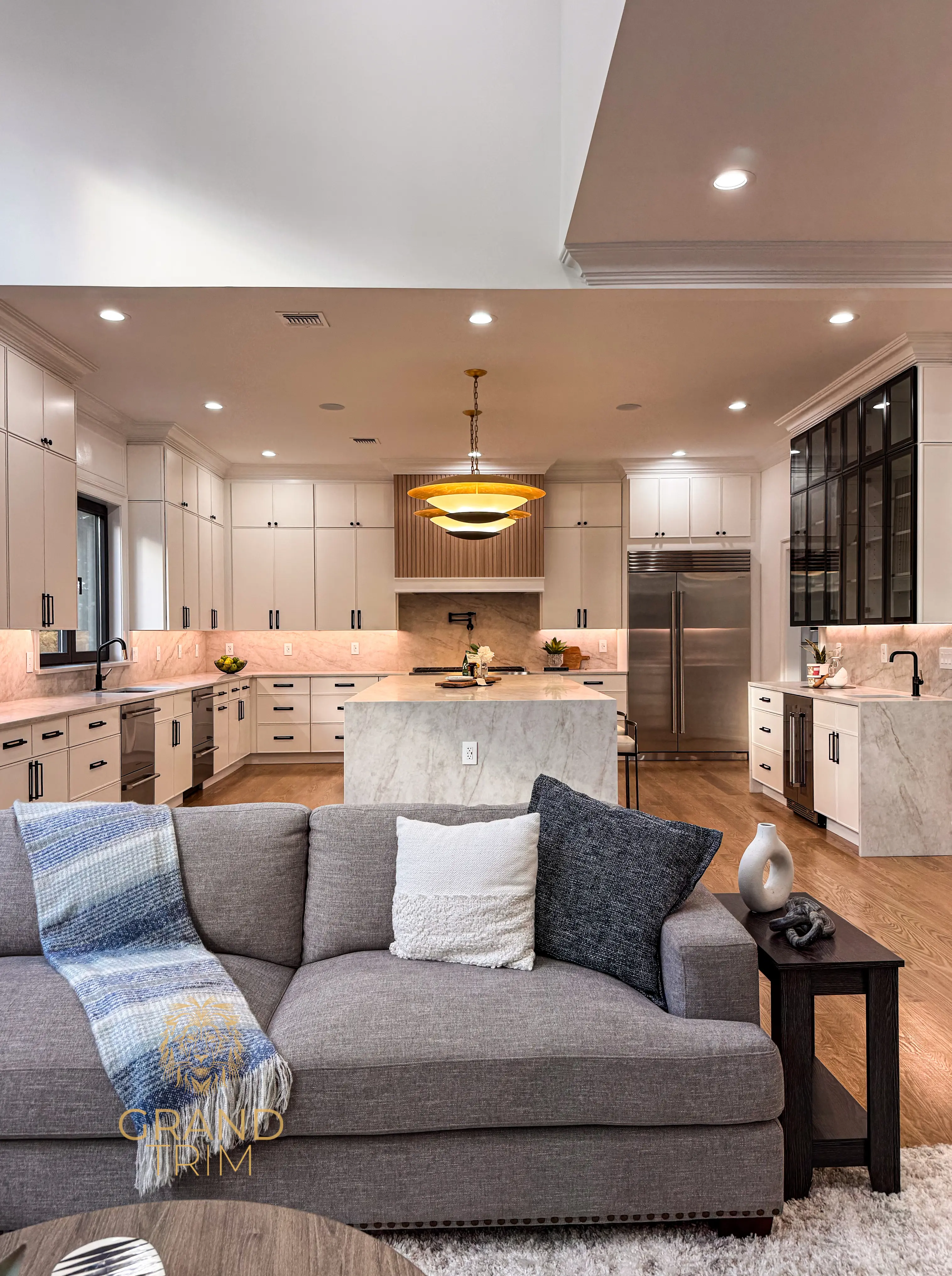 Modern white kitchen cabinets with marble countertops and extensive crown molding in a New Jersey home