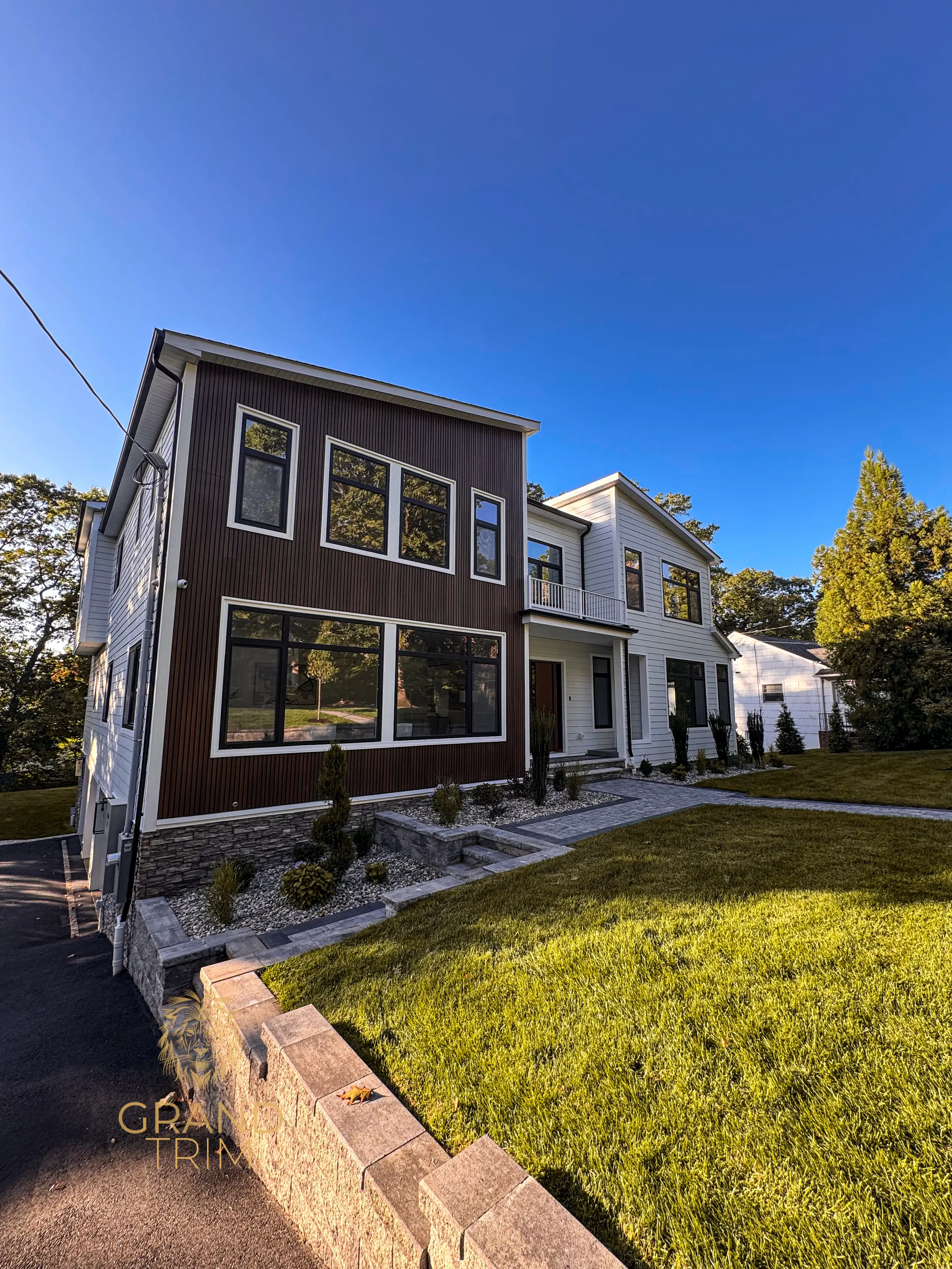 Modern home exterior with dark vertical wall paneling and white siding in New Jersey