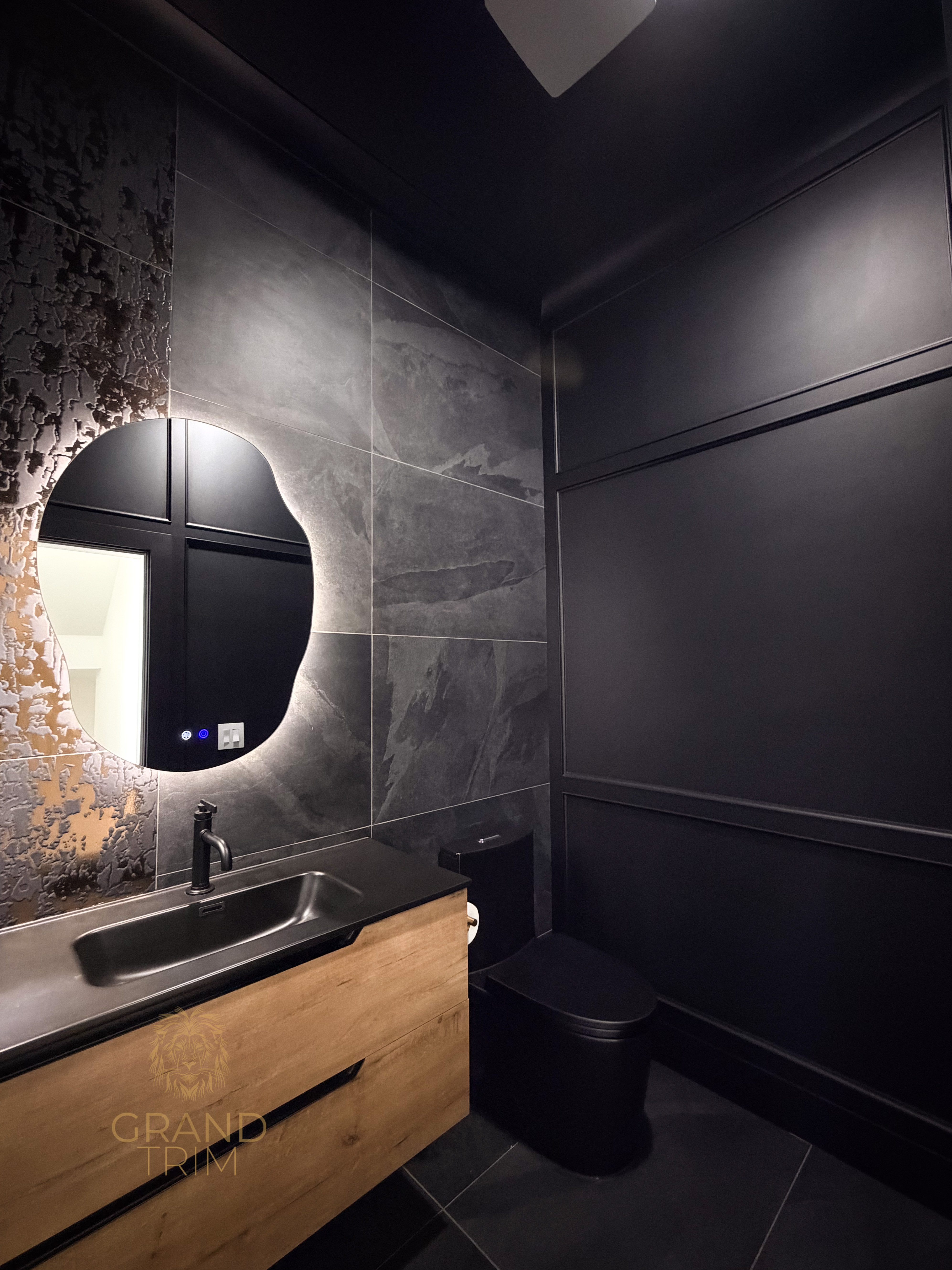 Dark full-height wall paneling with rectangular profiles in a modern New Jersey powder room