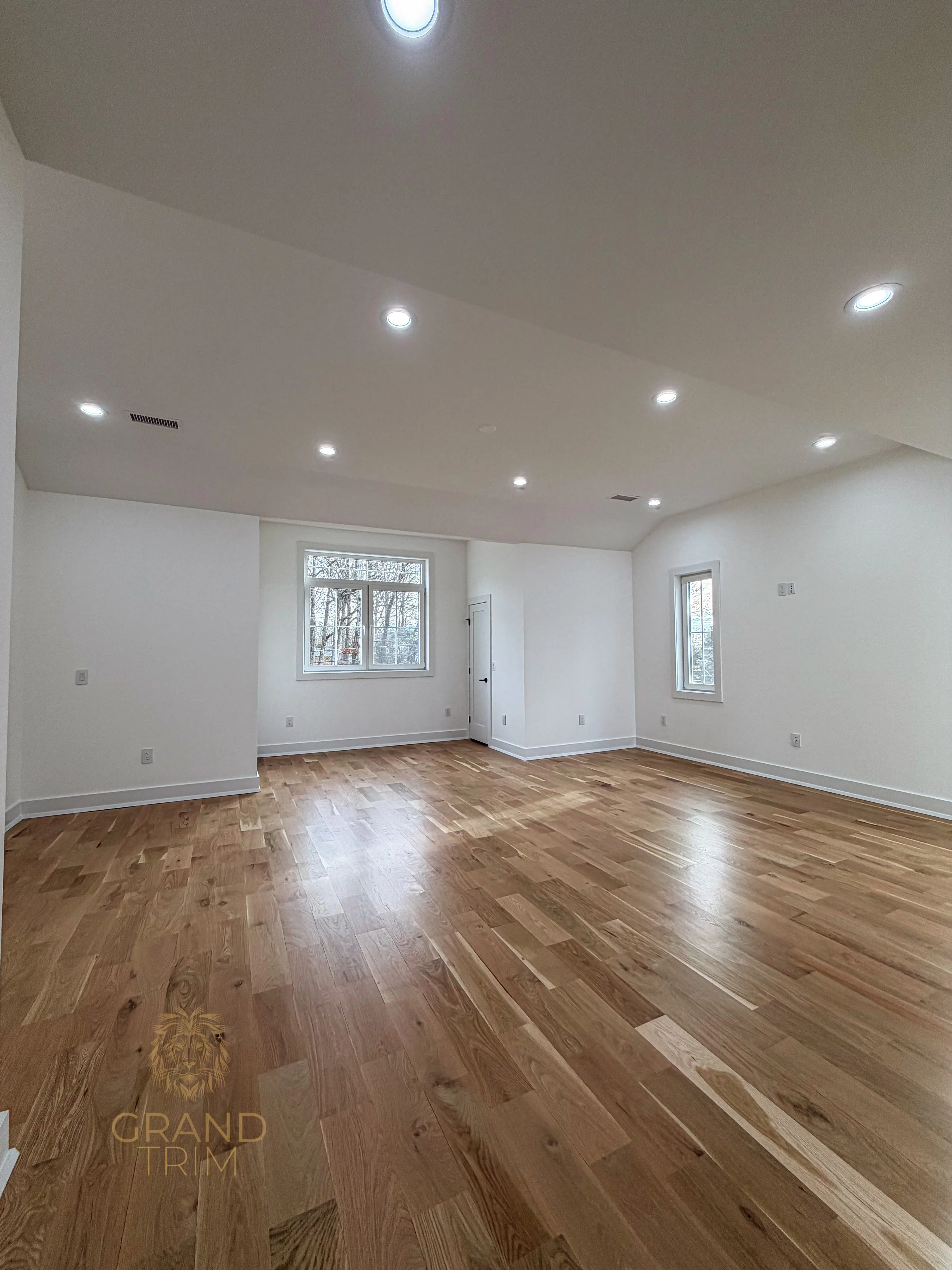 Newly renovated room in New Jersey with white trim including baseboards and window casing on white walls