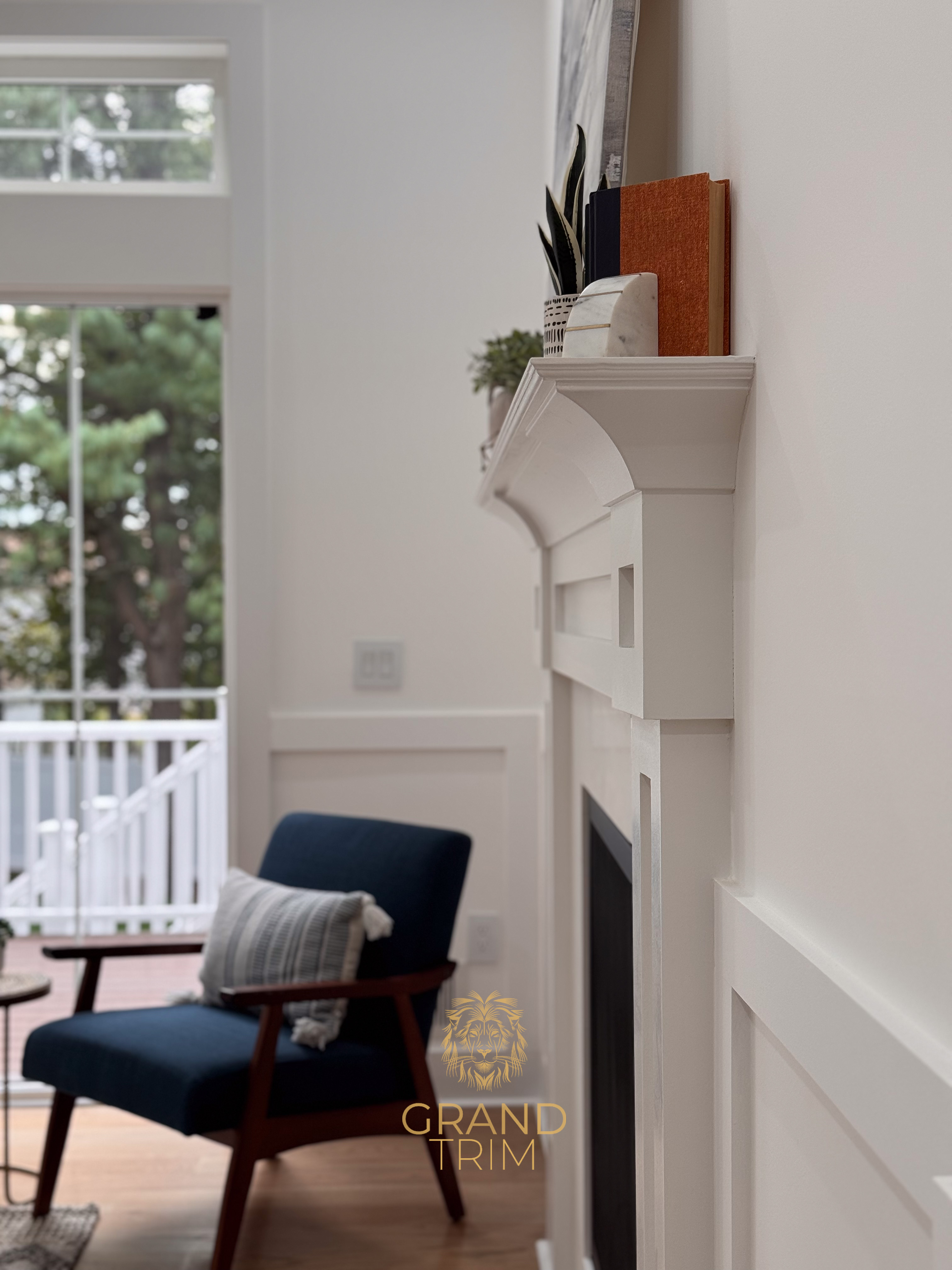 Custom white fireplace mantel and surround with decorative wall paneling in a bright New Jersey living room