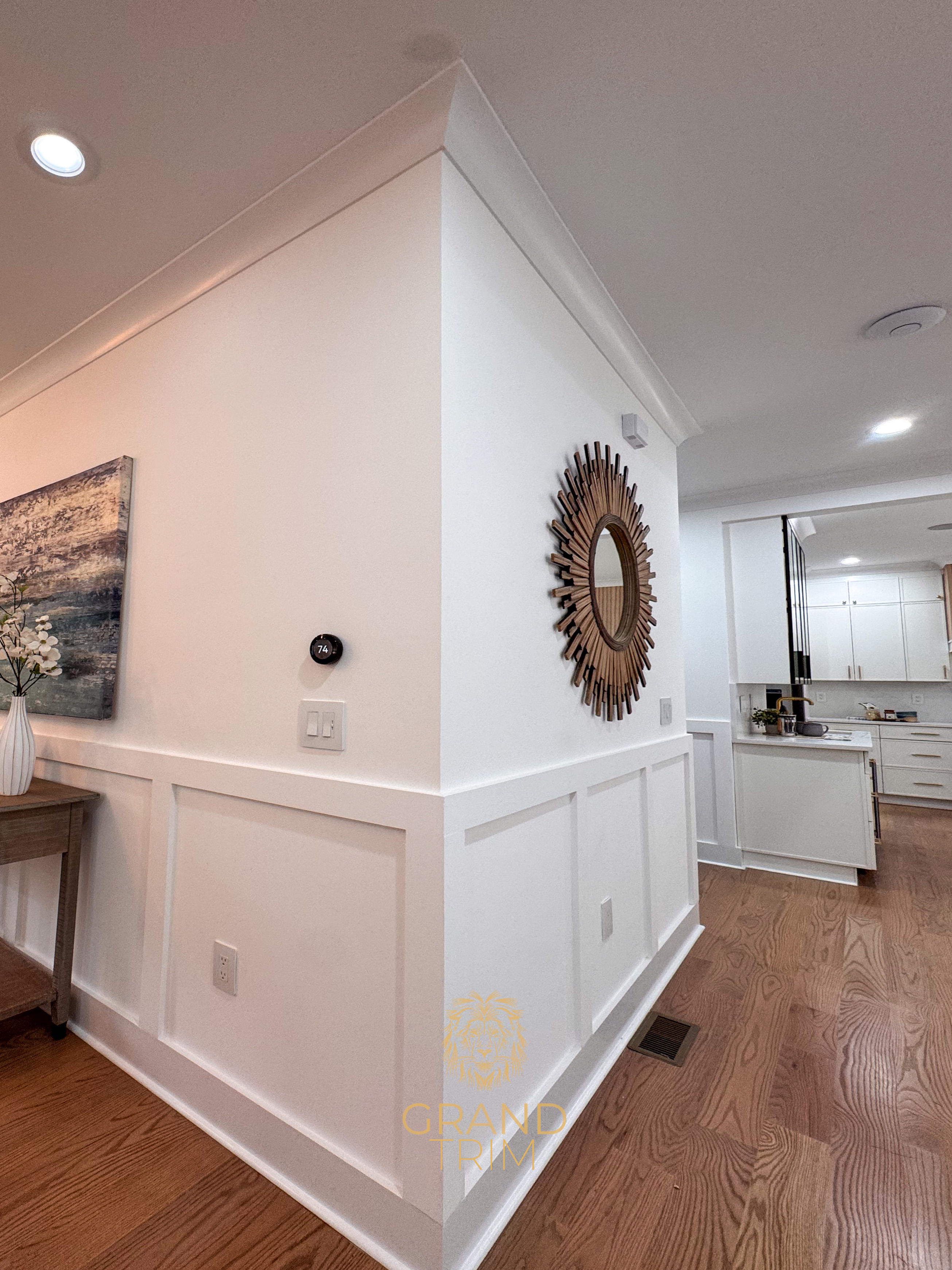 White wainscoting style wall paneling and ornate crown molding in a New Jersey home entryway