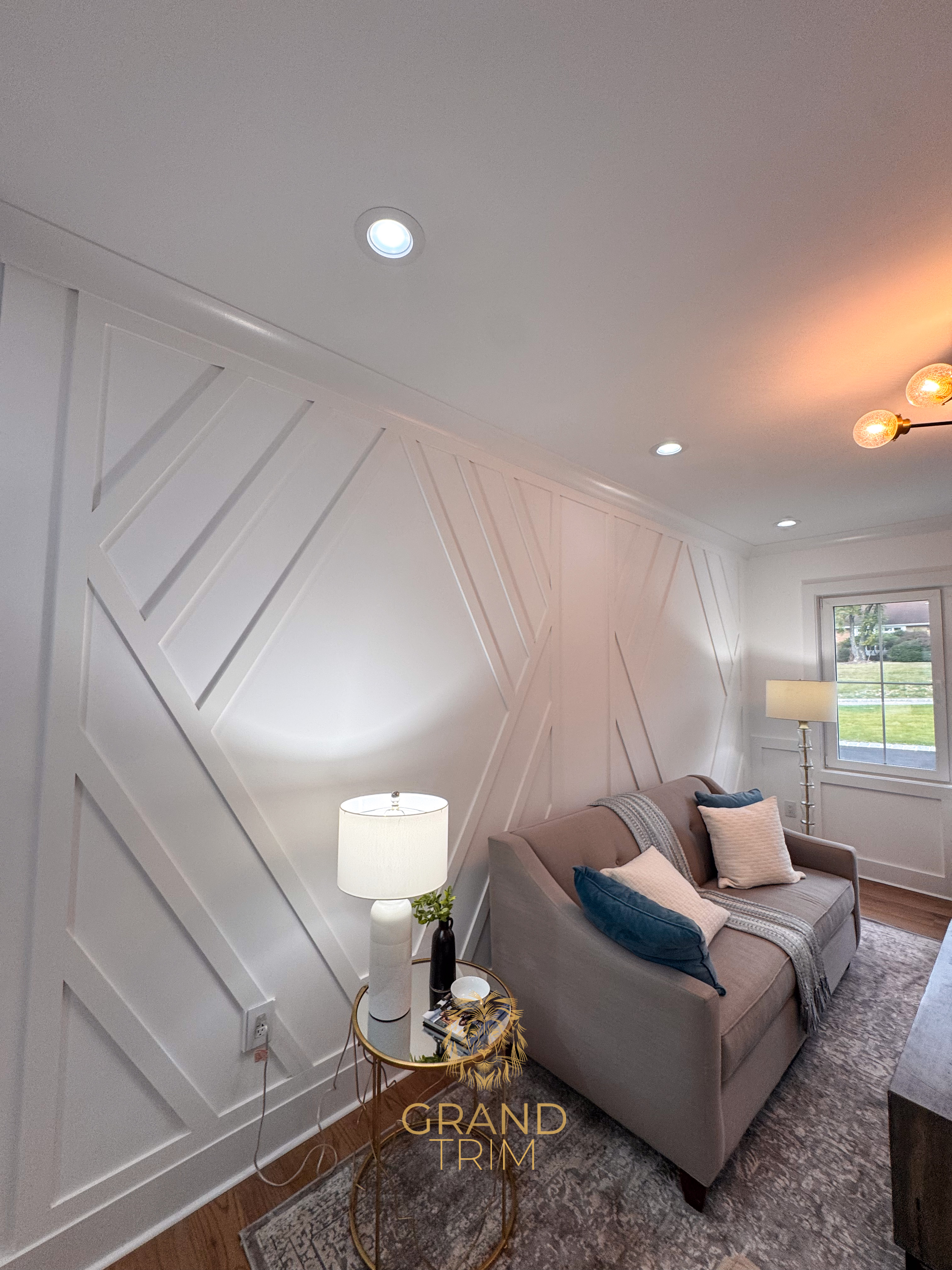 White diagonal wall paneling and crown molding in a modern New Jersey living room