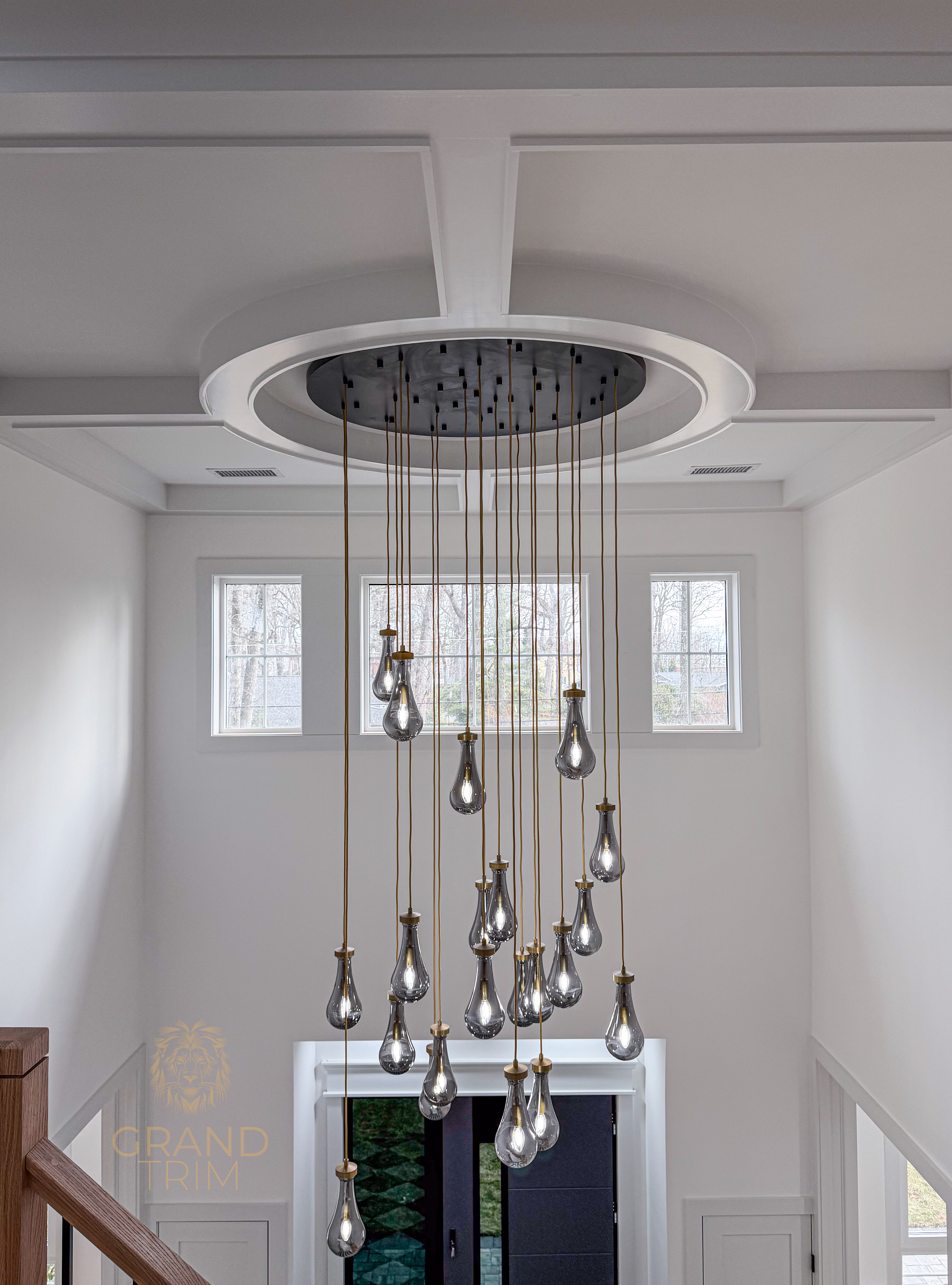 White multi-level tray ceiling with recessed panels and a large chandelier in a modern NJ entryway