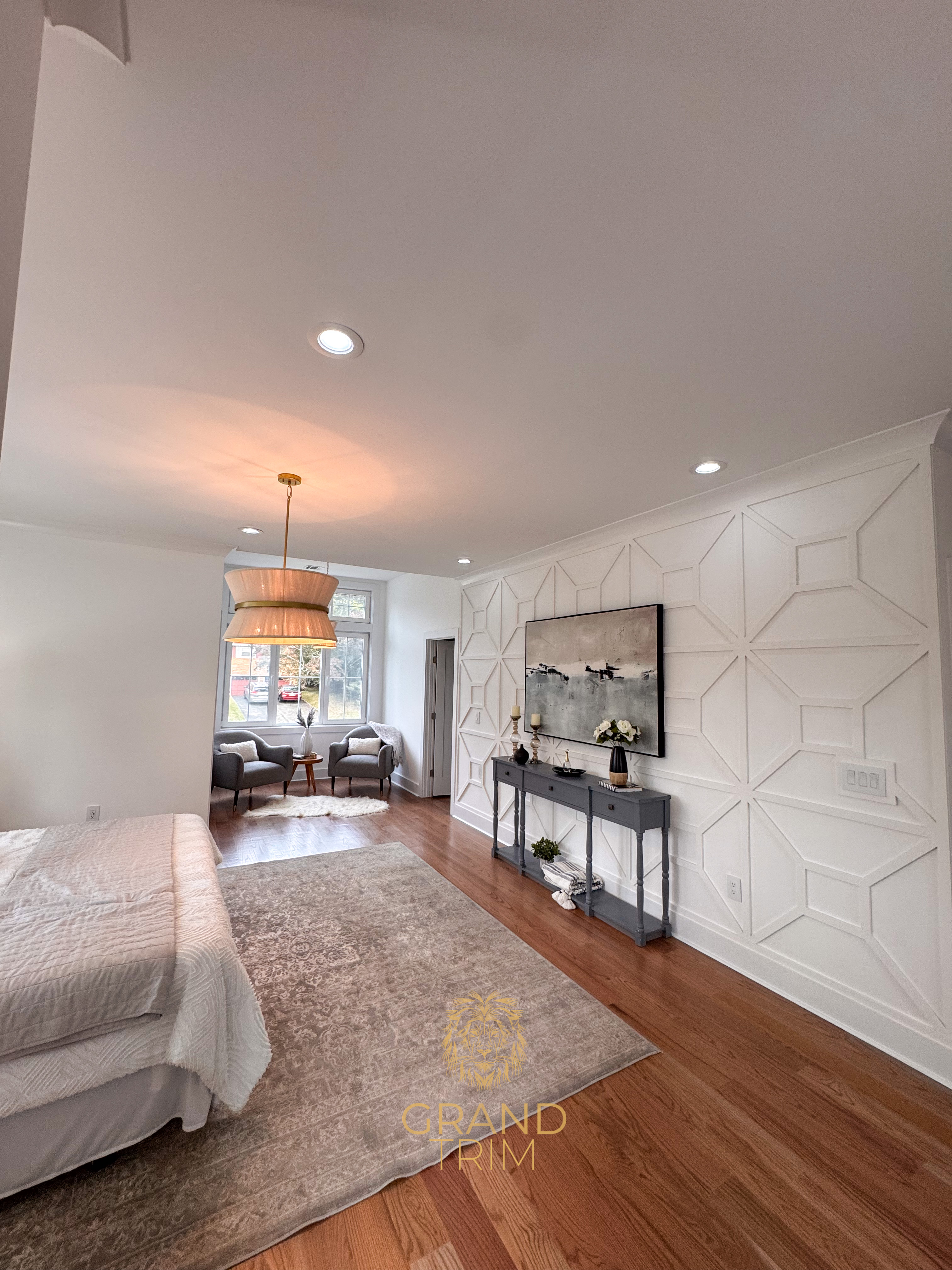 White geometric wall paneling with crown molding along the ceiling in a modern New Jersey bedroom