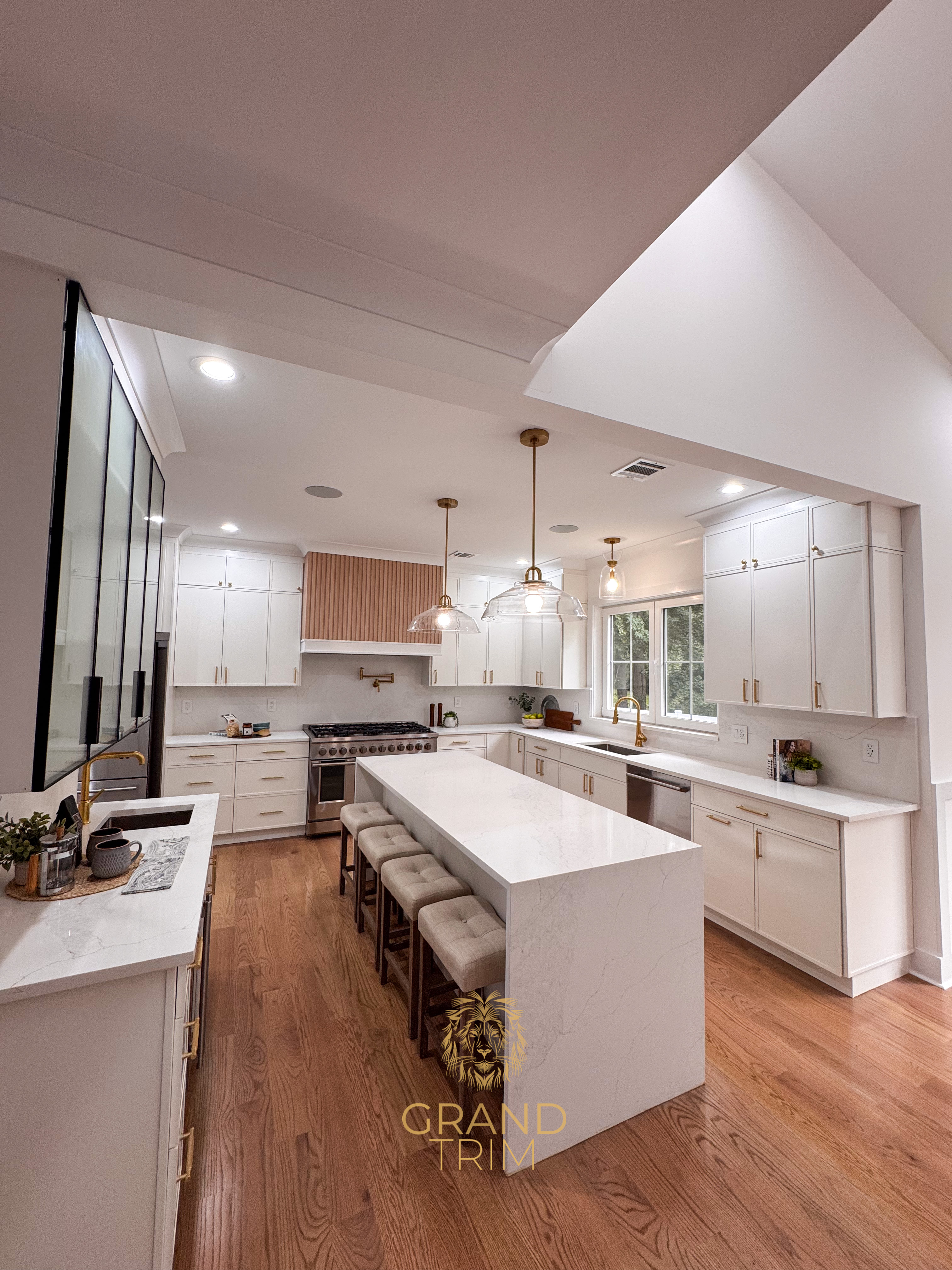 Modern white kitchen with shaker cabinets, large island, and stepped tray ceiling in a New Jersey home