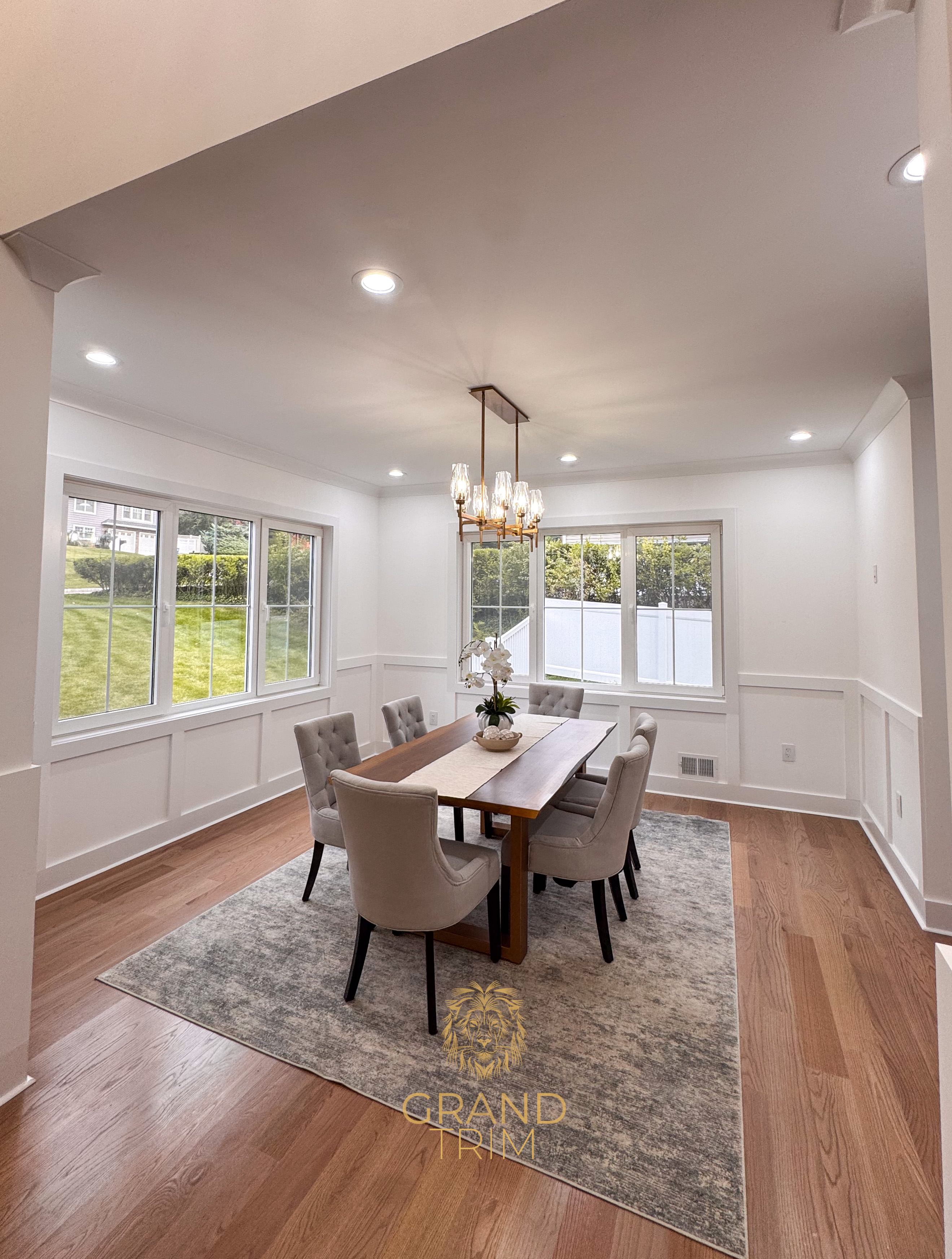 White wainscoting wall paneling in a bright modern dining room with hardwood floors in NJ