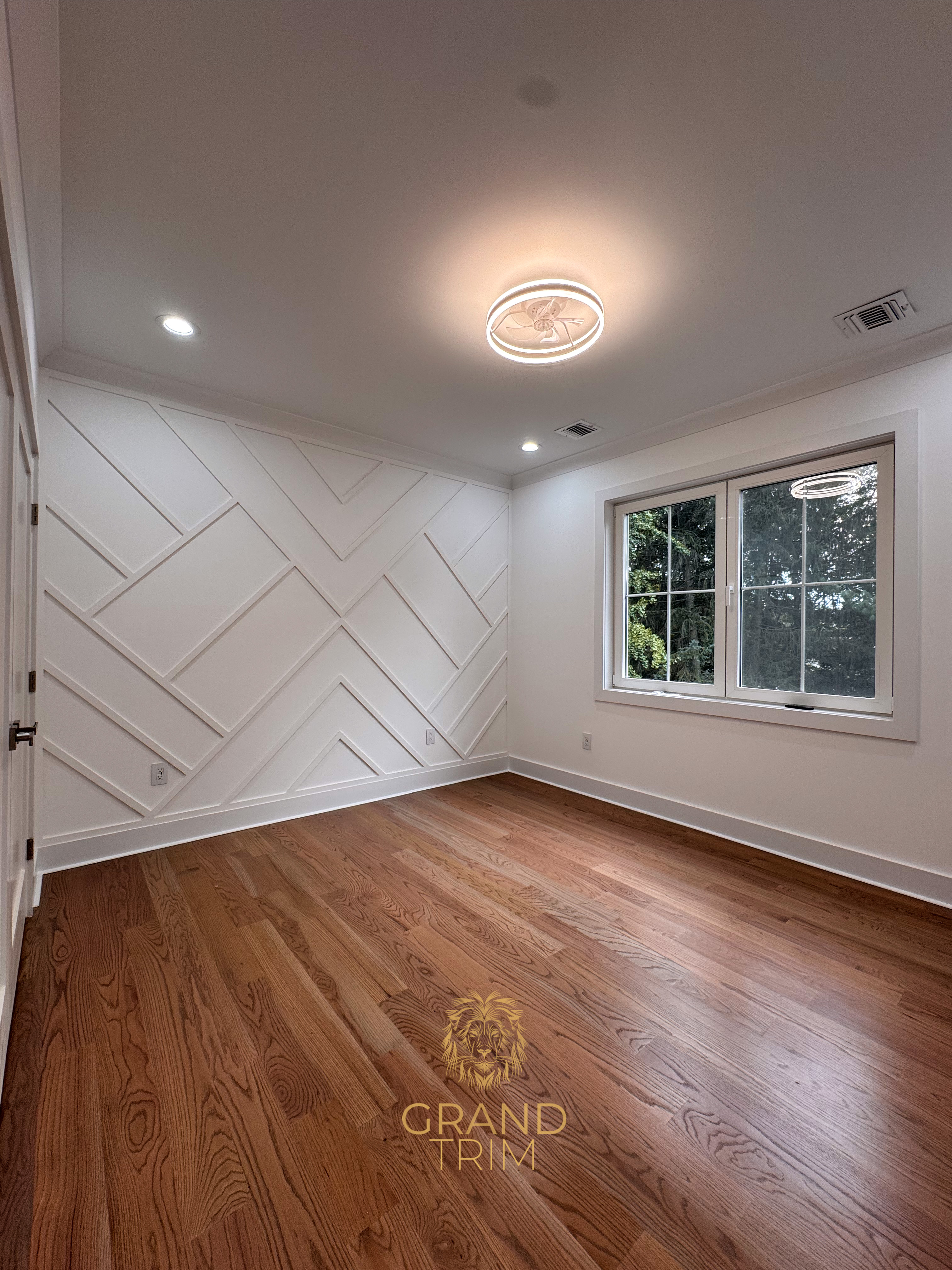 White geometric wall paneling with crown molding in a New Jersey empty room