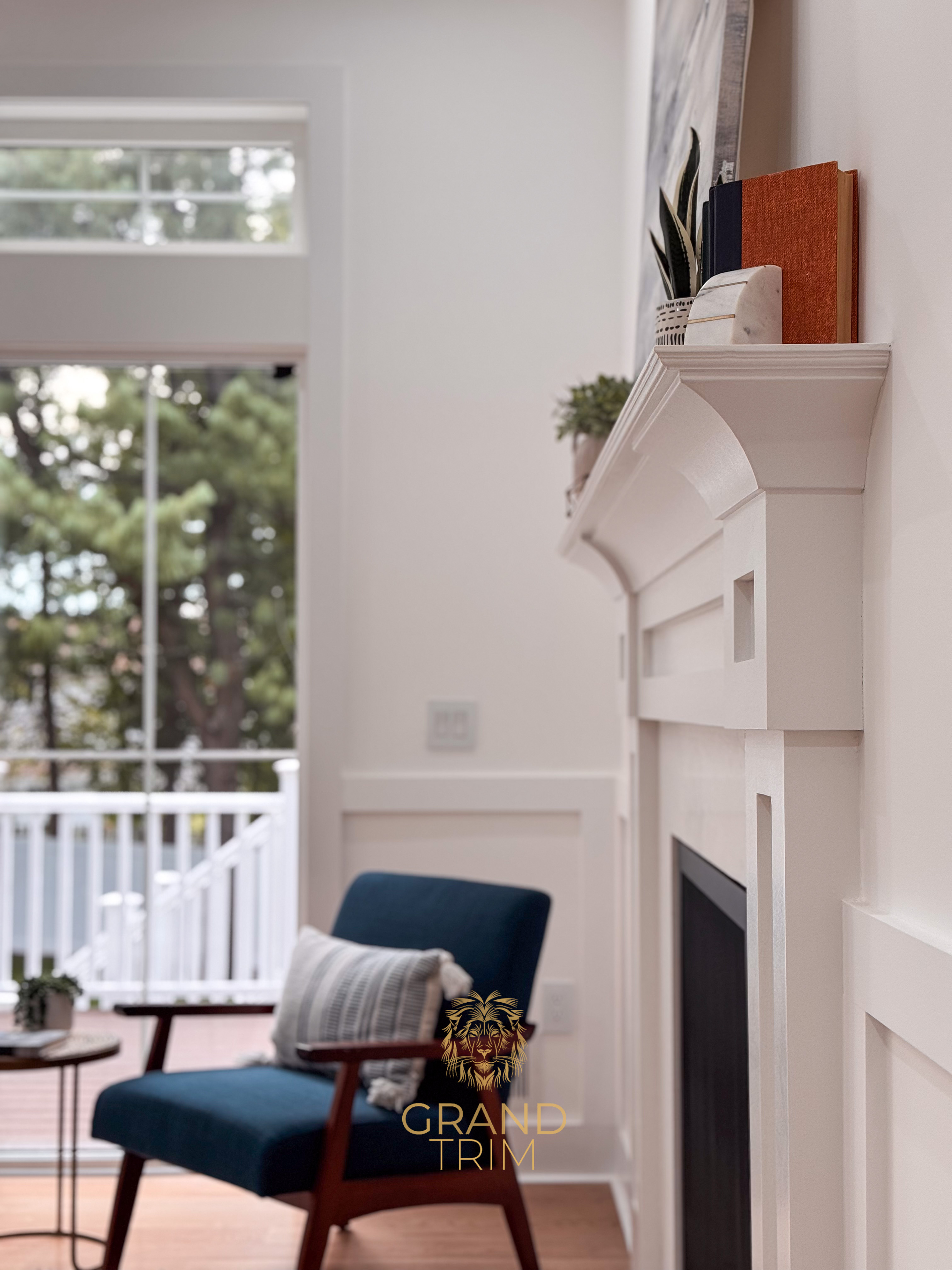 White custom fireplace mantel and surround with wainscoting in a bright New Jersey living room