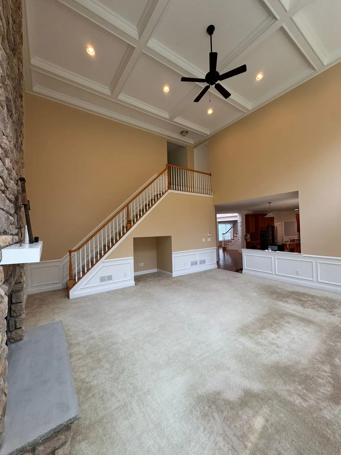 White coffered ceiling and wainscoting wall paneling in a spacious New Jersey living room