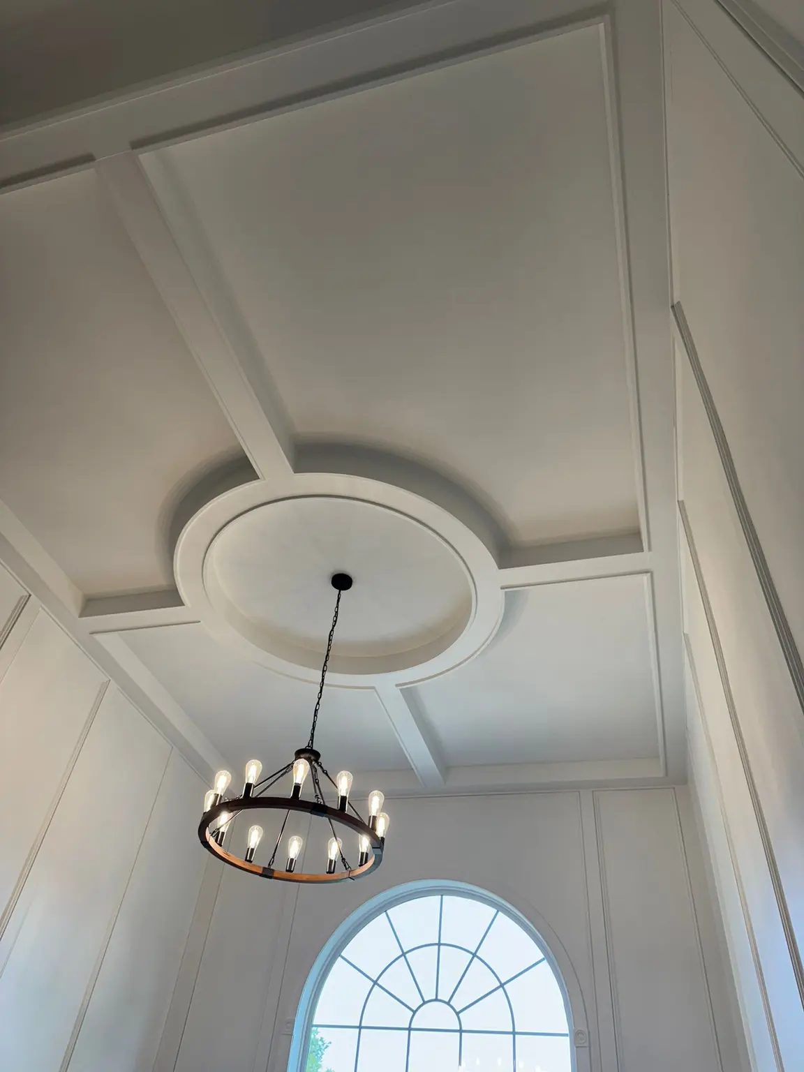 White coffered ceiling with a central medallion and complementary wall paneling in a high-ceiling New Jersey room