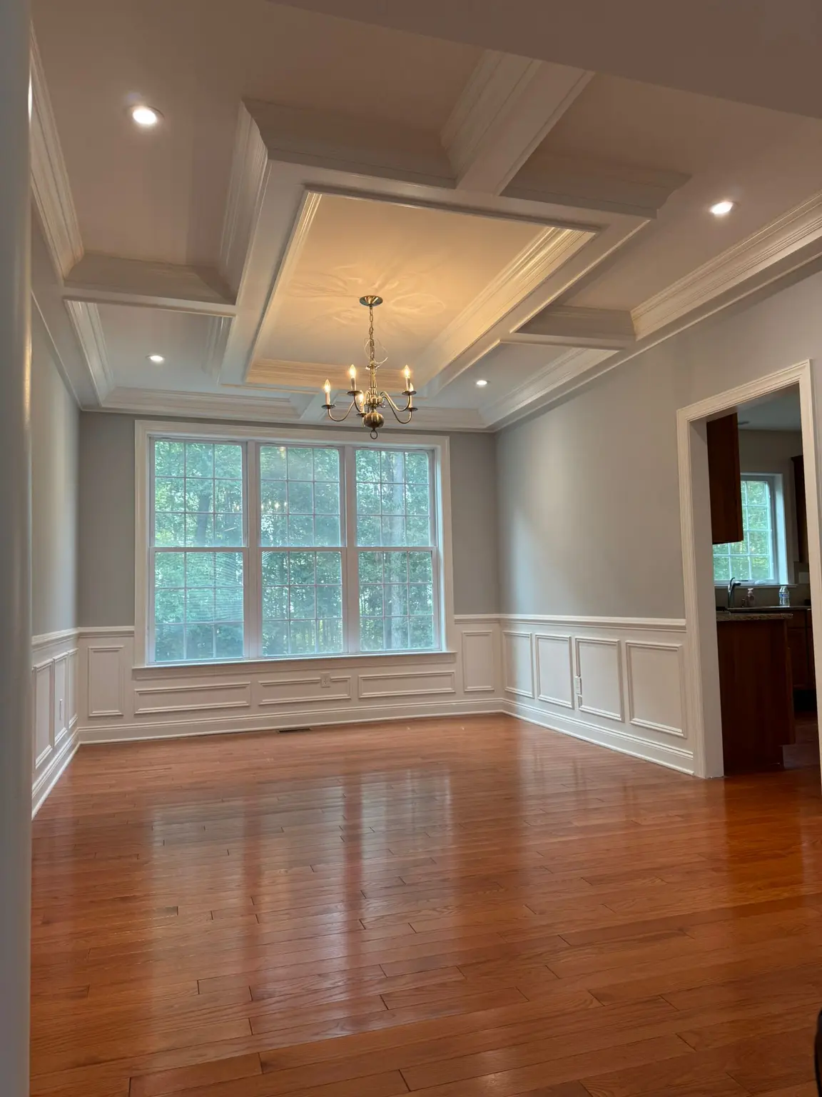 Elegant white coffered ceiling and wainscoting in a New Jersey home