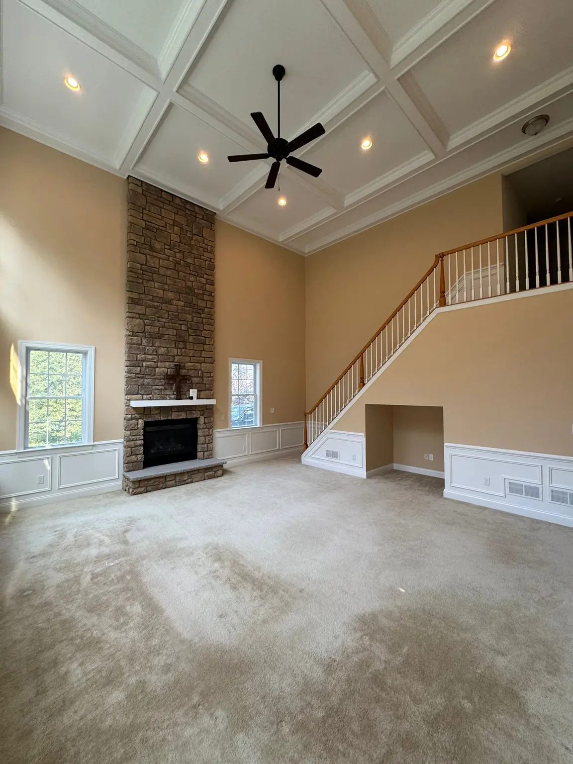 White coffered ceiling with recessed panels and wainscoting in a New Jersey living room